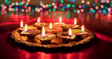 Happy Diwali. Diya oil lamps lit at Deepavali celebration. Hindu Festival of lights, close up vie