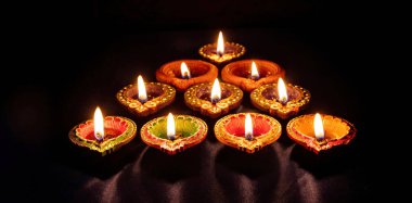 Diwali. Deepavali Hindu festival of lights. Clay diya candle. Oil lamp lit on dark backgroun