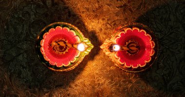 Diwali, Deepavali Hindu Festival of lights celebration. Diya oil lamp lit, on Puja thali, top view.