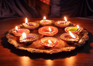 Happy Diwali. Diya oil lamps lit at Deepavali celebration. Hindu Festival of lights outdoors, India streets.