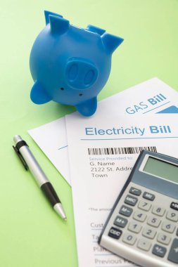 Elektrik, benzin ve kumbara faturaları. Isıtma ve enerji maliyeti artışı ve tasarruf kavramı.