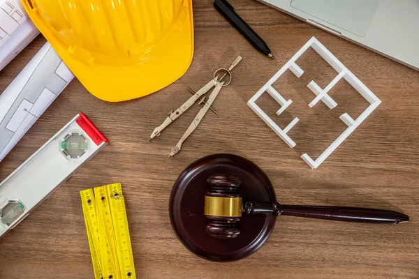 Construction and Labor law flat lay. Judge gavel and design tools on wooden table, top view.