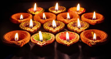 Diwali. Deepavali Hindu festival of lights. Clay diya candle. Oil lamp lit on dark backgroun
