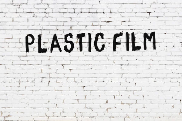 Inscription Plastic Film Written Black Paint White Brick Wall — Stock Photo, Image