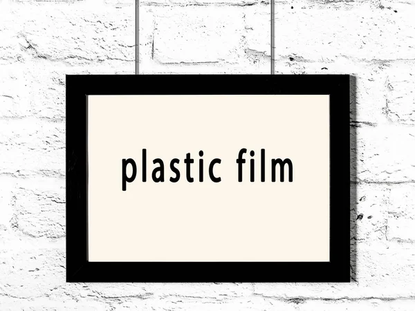 Svart Träram Med Inskription Plastfilm Hängande Vit Tegelvägg — Stockfoto