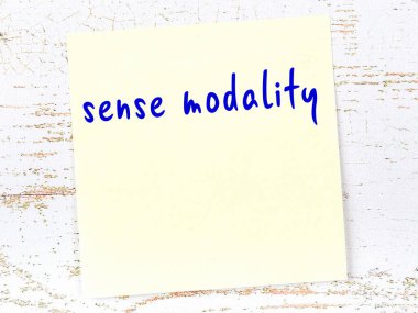 Duygu modalitesi hakkında hatırlatma kavramı. Tahta duvarda üzerinde yazı olan sarı yapışkan kağıt.