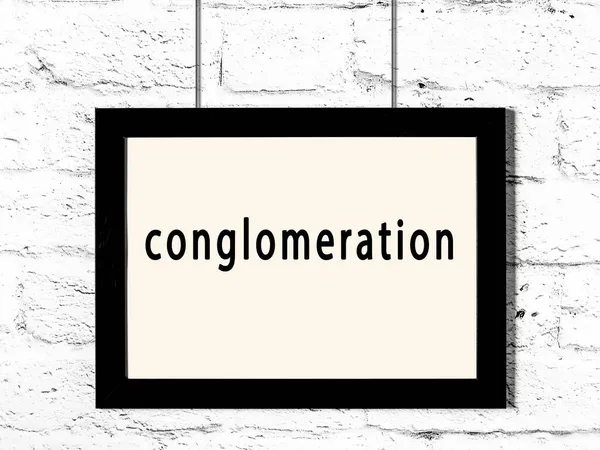 Black Wooden Frame Inscription Conglomeration Hanging White Brick Wall — Stock Photo, Image