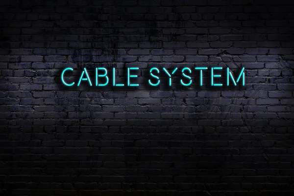 Neon sign on brick wall at night. Inscription cable system