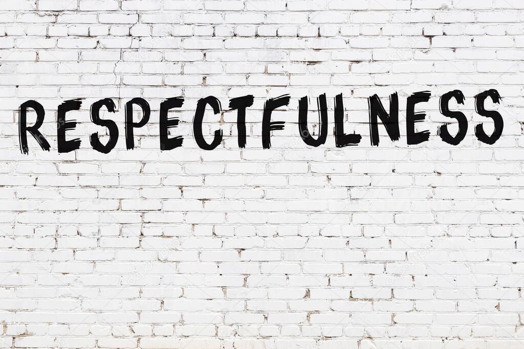 Inscription respectfulness written with black paint on white brick wall.