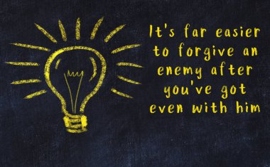 Bilgece bir alıntı ve siyah karatahtaya bir ampul çizimi