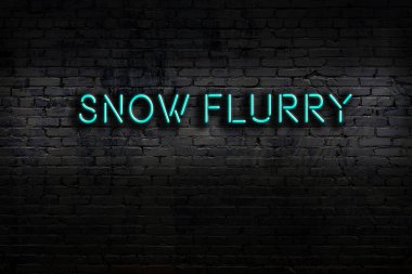 Neon sign on brick wall at night. Inscription snow flurry