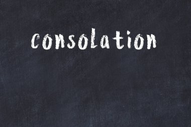 Inscription consolation written with black paint on white brick wall.