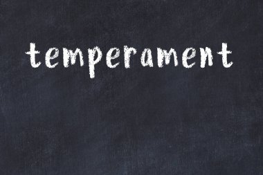 Inscription temperament written with black paint on white brick wall.