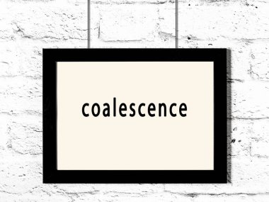 Black wooden frame with inscription coalescence hanging on white brick wall 