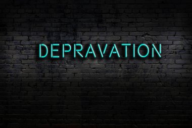 Neon sign with inscription depravation against brick wall. Night view