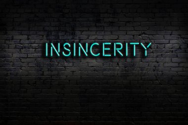 Neon sign on brick wall at night. Inscription insincerity