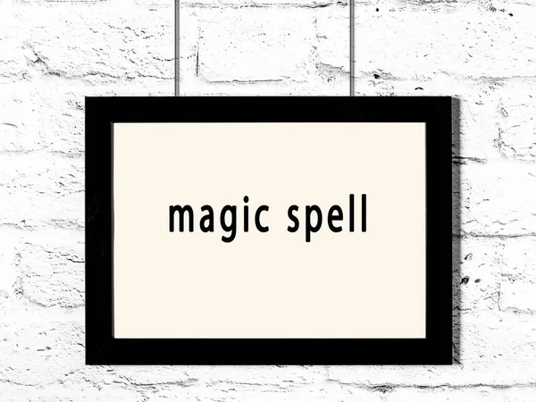 Black Wooden Frame Inscription Magic Spell Hanging White Brick Wall — Stok fotoğraf