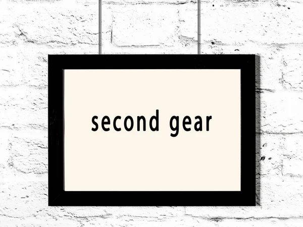 Black Wooden Frame Inscription Second Gear Hanging White Brick Wall — Stockfoto