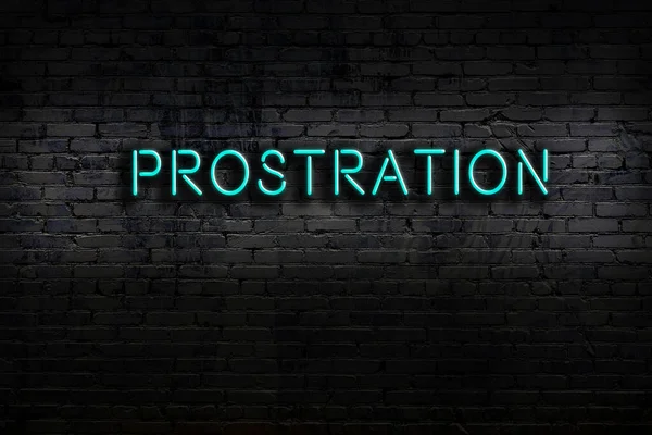Neon sign on brick wall at night. Inscription prostration