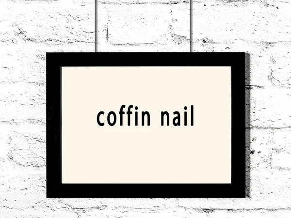 Black Wooden Frame Inscription Coffin Nail Hanging White Brick Wall — Stockfoto