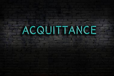 Neon sign on brick wall at night. Inscription acquittance