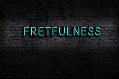 Neon sign on brick wall at night. Inscription fretfulness