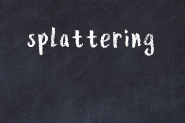 Inscription splattering written with black paint on white brick wall.