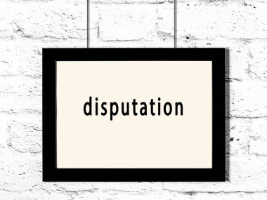 Black wooden frame with inscription disputation hanging on white brick wall 