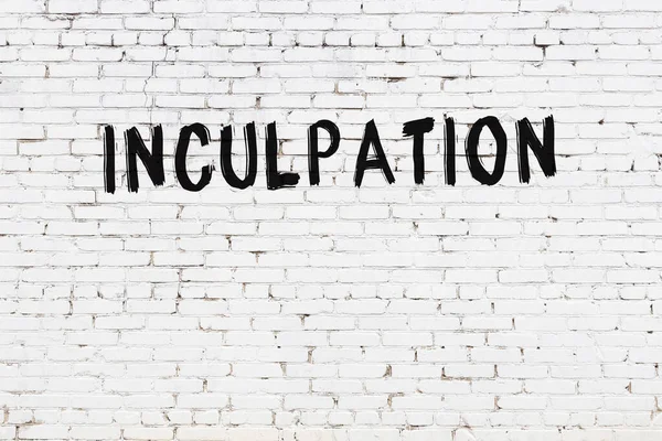 Inscription Inculpation Written Black Paint White Brick Wall — Foto Stock