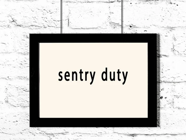 Black Wooden Frame Inscription Sentry Duty Hanging White Brick Wall — 스톡 사진