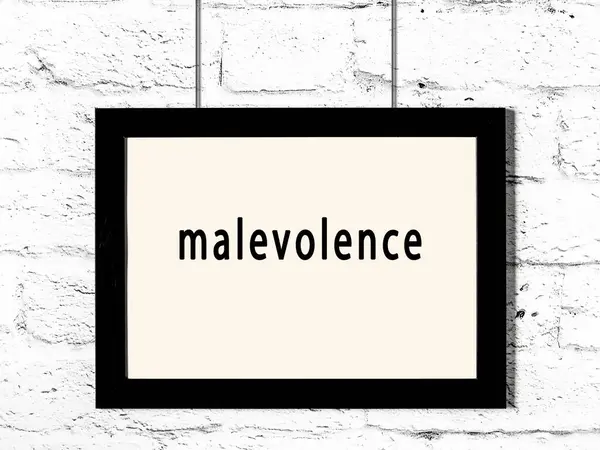 Black Wooden Frame Inscription Malevolence Hanging White Brick Wall — Stockfoto