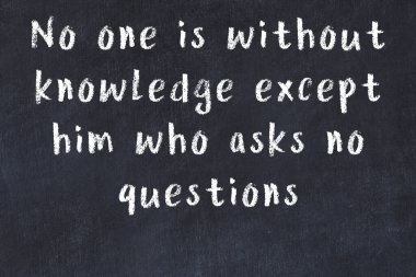 Siyah masa üzerine tebeşirle yazılmış zekice bir söz.