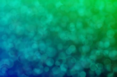 Nane yeşili ve koyu yeşil soyut çözünmüş arkaplan daire şeklindeki bokeh noktalarıyla