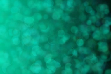 Yeşil ve mavi renkli ve daire şeklindeki desenlere sahip soyut ve güzel harmonik arkaplan.