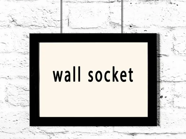 Black Wooden Frame Inscription Wall Socket Hanging White Brick Wall — Stock Photo, Image