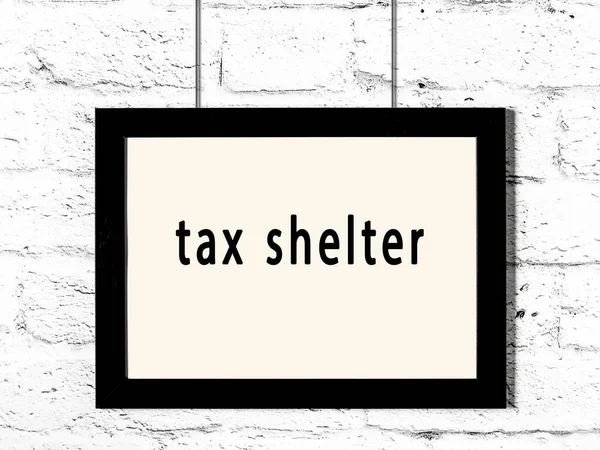 Black Wooden Frame Inscription Tax Shelter Hanging White Brick Wall — Stock Photo, Image