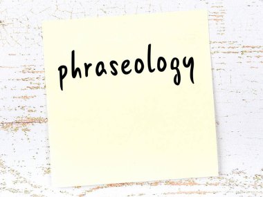 Cümleleri hatırlatma kavramı. Tahta duvarda üzerinde yazı olan sarı yapışkan kağıt.