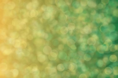 Hardal ve yeşil soyut çözünmüş arkaplan, daire şeklinde bokeh desen.