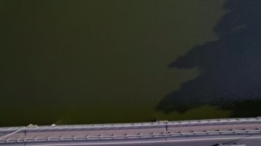 Nehrin üzerinden köprüye doğru uçan hava görüntüsü. Araba köprüden geçiyor.