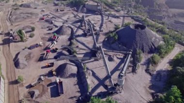Excavators and tractors load crushed stone and rock into dump trucks. Mining truck transporting stone