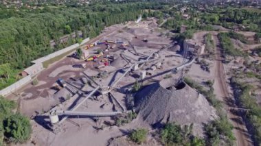 The excavator loads the crushed stone in a truck. Quarry for the extraction of gravel. Production, transportation