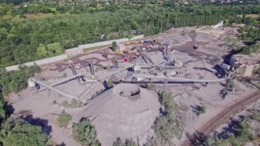 Aerial view of stone crusher plant machine in work process, conveyor belt and hopper feeder