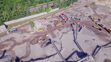 The excavator loads the crushed stone in a truck. Quarry for the extraction of gravel. Production, transportation