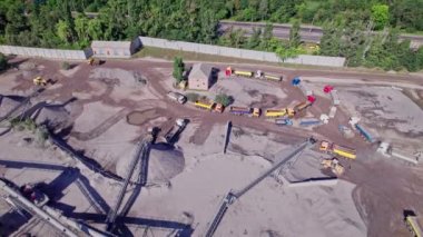 Aerial view of stone crusher plant machine in work process, conveyor belt and hopper feeder