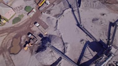 Stone sorting conveyor belt in a large quarry, top down aerial view