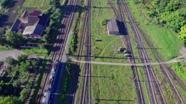 Aerial view from flying drone of colorful freight trains on the railway station