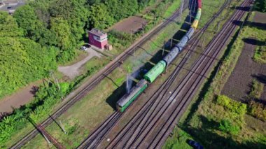 Aerial view from flying drone of colorful freight trains on the railway station