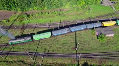 Aerial view from flying drone of colorful freight trains on the railway station