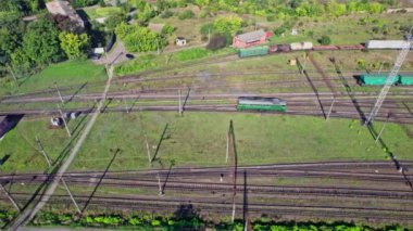 Aerial view from flying drone of colorful freight trains on the railway station