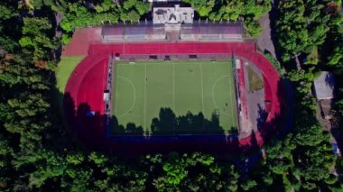 Önünde küçük bir futbol stadyumu olan havacılık şehri manzarası.